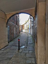 Empty alley amidst buildings in city