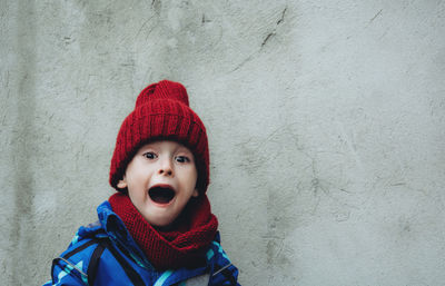 Portrait of a screaming child with a pumpkin. the kid expresses fear. halloween and holiday concept.