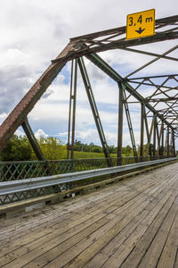 Close-up of yellow bridge against sky