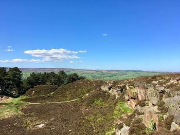 Scenic view of landscape against blue sky