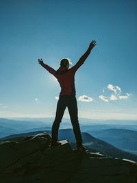 Full length of man standing on mountain against sky