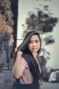 Portrait of young woman standing outdoors