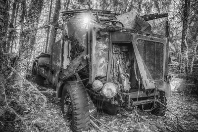 Old abandoned car on field