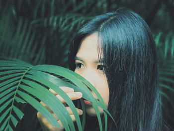 Close-up of young woman amidst plants