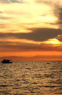 Scenic view of sea against orange sky