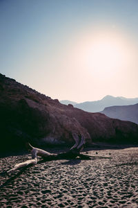 Scenic view of lake by mountains against clear sky