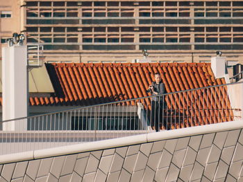 Man working on railing of building