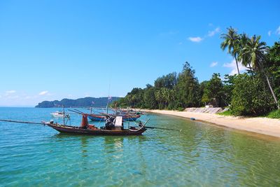 Boat in sea against blue sky