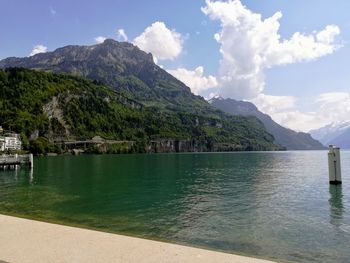 Scenic view of lake and mountains against sky