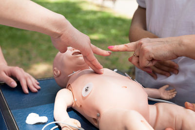 Rescue workers performing cpr on baby mannequin