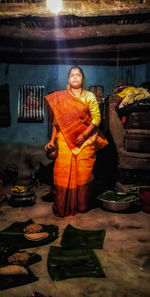 Portrait of woman standing at market stall