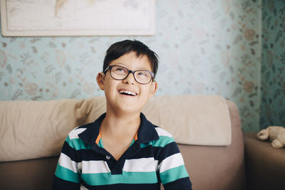 Portrait of smiling boy against wall