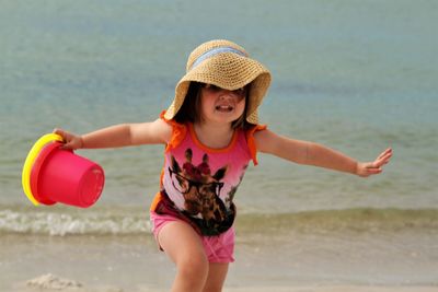 Cute scared running on shore at beach