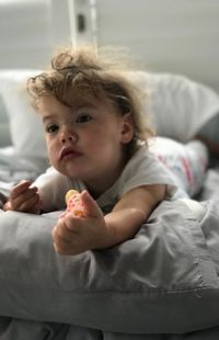 Cute boy lying on bed at home