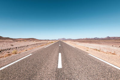 Scenic view of road against clear blue sky