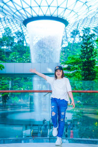 Portrait of woman standing against built structure