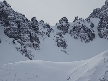 Scenic view of snow covered mountains against sky