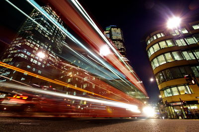 Low angle view of illuminated buildings in city at night