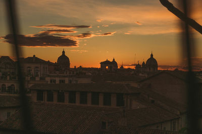 Buildings against sky during sunset in city