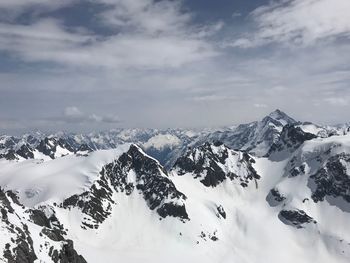 Scenic view of snow covered mountains against sky