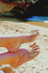 Close-up of a hand holding sand