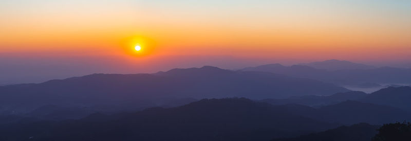 Scenic view of silhouette mountains against sky during sunset