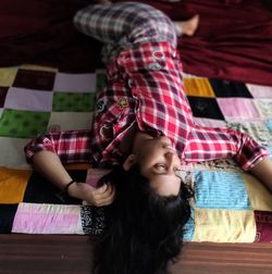 Woman lying down on bed at home