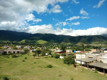 Houses on landscape against sky