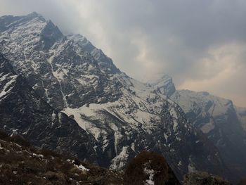 Scenic view of mountains against cloudy sky