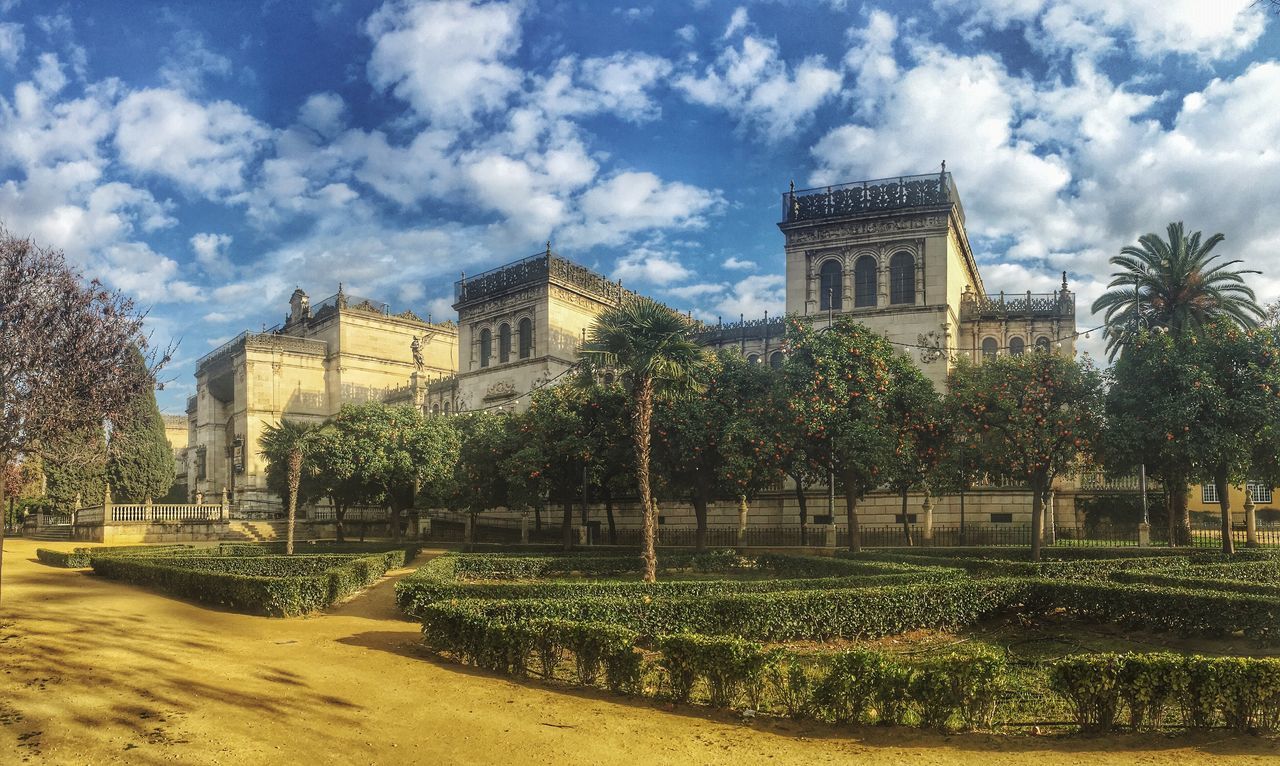 architecture, building exterior, built structure, sky, tree, cloud - sky, city, growth, cloud, plant, lawn, tower, flower, day, green color, grass, travel destinations, famous place, park - man made space, formal garden