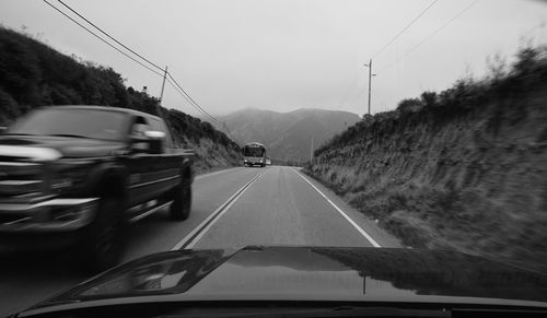 Cars on road against sky