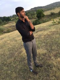 Young man standing on field