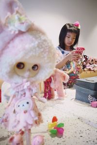 Portrait of cute girl holding pink flower