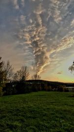 Scenic view of field against sky during sunset