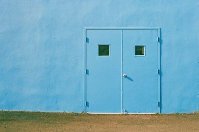 Closed blue door of building