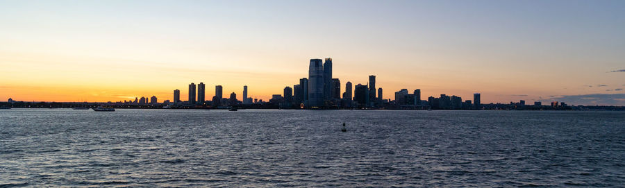 Jersey city silhouetted against a dramatic sunset