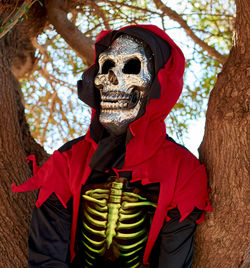 Person wearing mask against trees