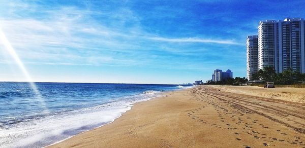 Scenic view of beach against sky in city