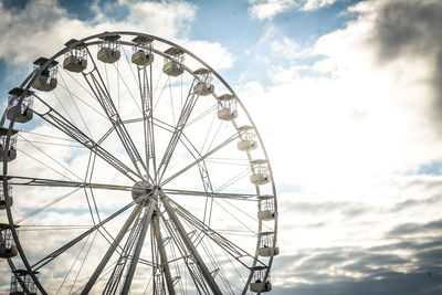 Low angle view of ferris wheel against sky