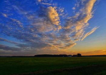 Scenic view of field against sky during sunset