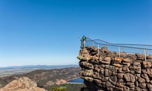 View of rocks against clear blue sky