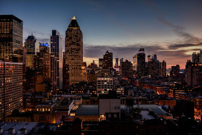 Illuminated cityscape against sky