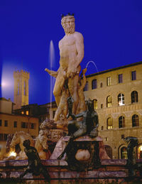 Low angle view of statue against blue sky