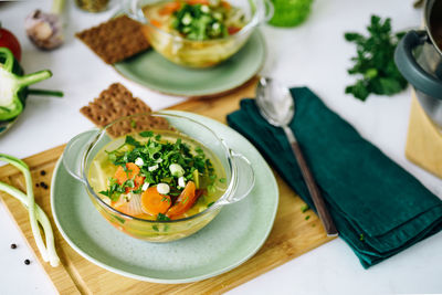 Two plates with vegan food, cabbage soup on the table at home