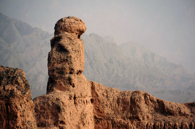 View of rock formations against mountain