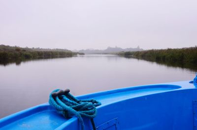 Boat moored in lake against clear sky