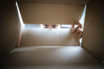 Person holding paper in box