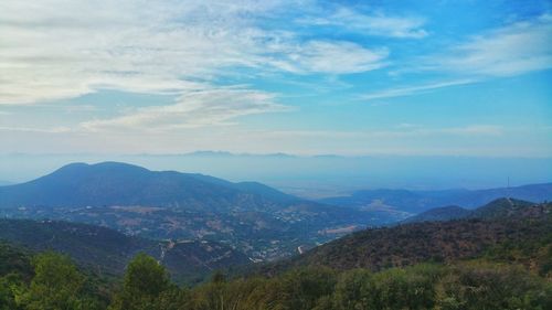 Scenic view of mountains against cloudy sky