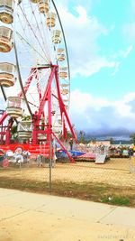 Ferris wheel against cloudy sky