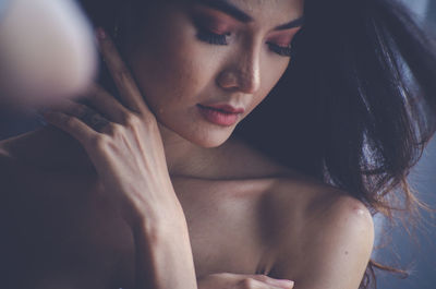 Close-up of young woman with make-up